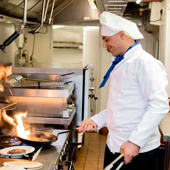 Camden Springs Chef Created Meals, chef frying a dish.