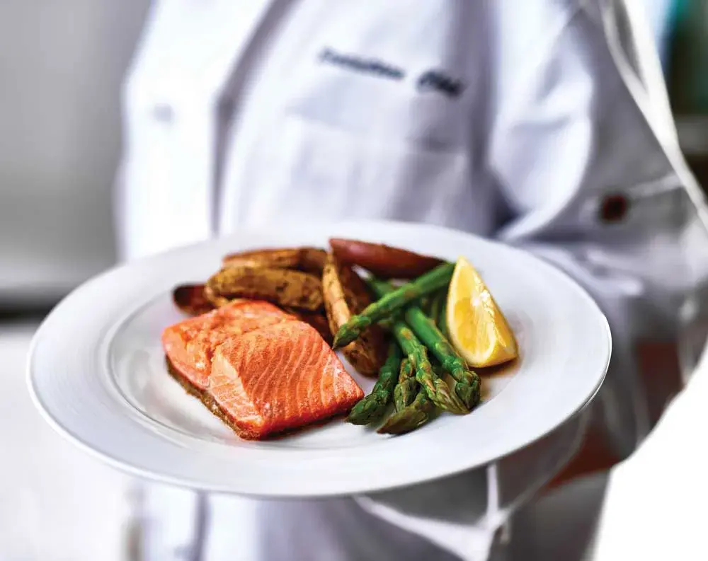 Camden Springs Chef Created Meals, chef delivering a finished dish.