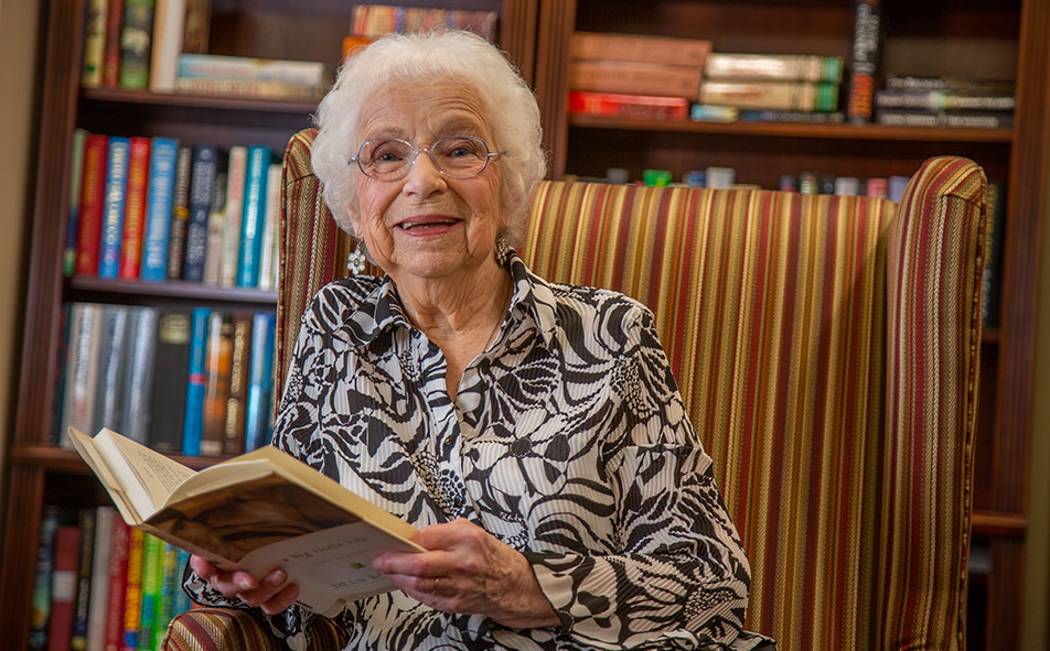 The library at Camden Springs with shelves of books and comfortable seating