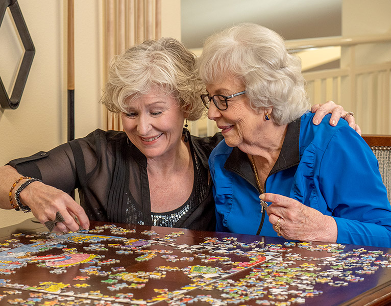 Residents working on a puzzle together at Camden Springs