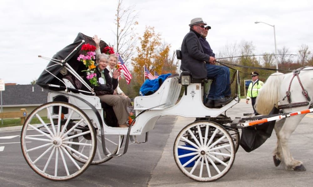Residents enjoying a horse-drawn carriage ride at Camden Springs